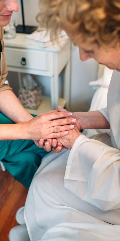 Doctor giving encouragement to elderly patient